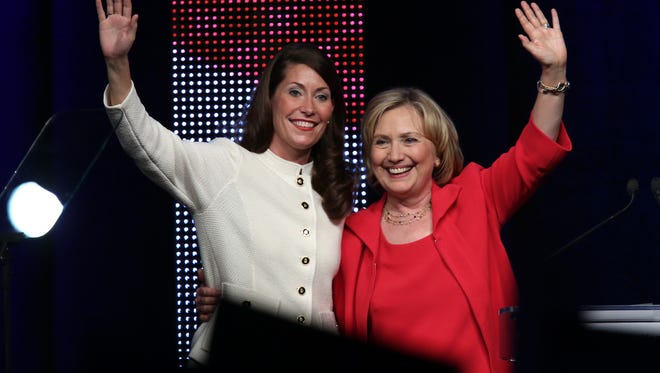 Former U.S. Secretary of State Hillary Clinton, right, campaigns for Alison Lundergan Grimes at the Kentucky International Convention Center in Louisville. Grimes is running against incumbent Sen. Mitch McConnell (R-Kentucky). Oct. 15, 2014.