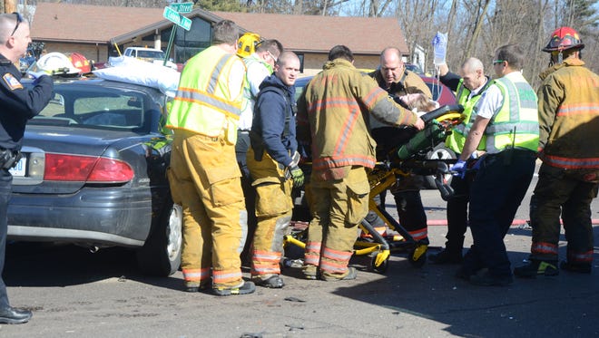 Emergency responders remove the driver of one vehicle involved in a crash Saturday.
