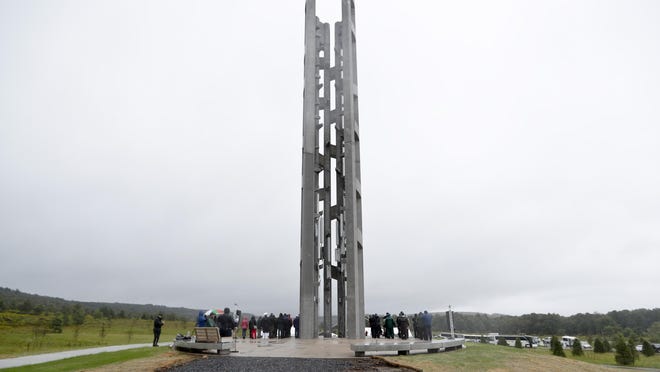 In this Sept. 9, 2018 file photo, people attending the dedication stand around the 93-foot tall Tower of Voices at the Flight 93 National Memorial in Stonycreek Township, Somerset County, where the tower contains 40 wind chimes representing the 40 people that perished in the crash of Flight 93 in the terrorist attacks of Sept. 11, 2001.