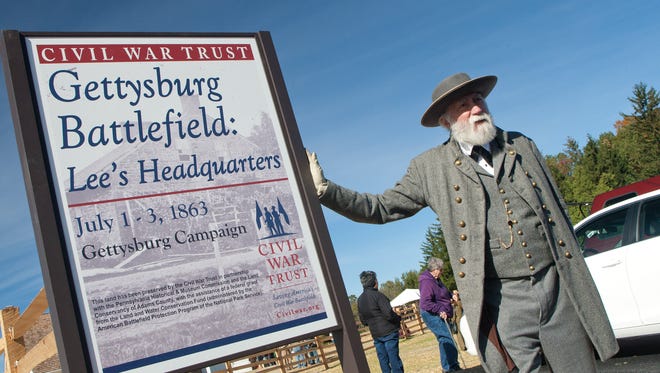 In this file photo from October 2016, living historian Frank Orlando of Gettysburg poses as "General Lee" for tourists along Seminary Ridge Friday.