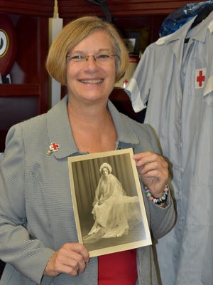 Executive Director Sarah Tippett Ruwe with a picture of her grandmother who volunteered in World War I for the Red Cross.