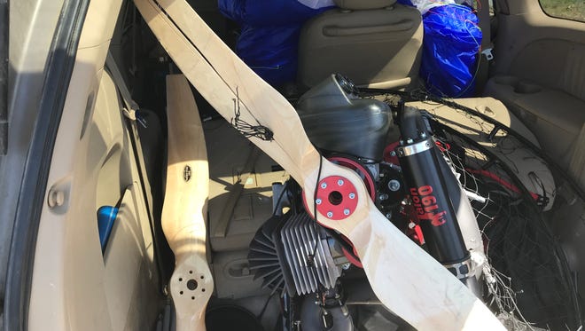 The engine portion of a motorised parachute that crashed Sunday south of Redding was loaded into a van and hauled away. A piece of netting appears to be stuck in the propeller.