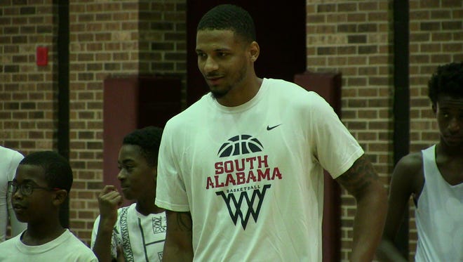 Prattville High graduate Dionte Ferguson worked with kids Wednesday at Earl Taylor's basketball camp at Prattville High.
