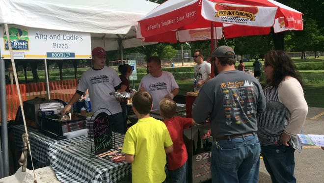 Patrons check out the Ang an Eddies Pizza booth Sunday during Taste of Fond du Lac at Lakeside Park.
