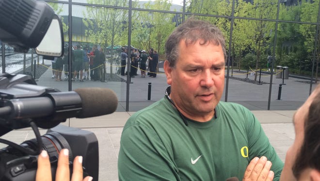 Oregon defensive coordinator Brady Hoke talks to reporters on media day earlier this month.