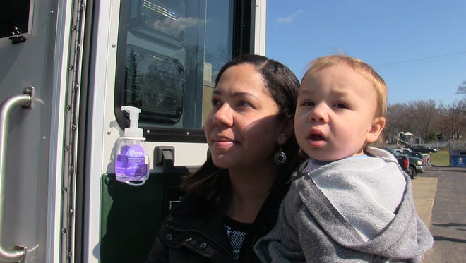 Ashley Shedd and her son, Devin Shedd, take a look at Bronson Healthcare's new pediatric transport ambulance Monday.