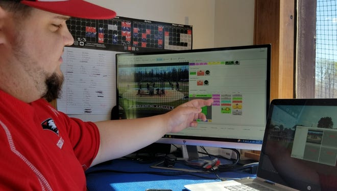 University of Southern Indiana junior student-manager Aaron Furman explains the new "Dartfish" technology the baseball team is using this season.