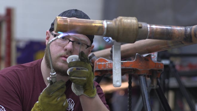Career and Technical Education Academy student Devin Carpenter works during his internship at Midwestern Mechanical. Sioux Falls schools are looking to expand internship opportunities for students.