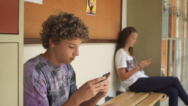 Students keep their eyes peeled on their phones in this scene from "Screenagers."