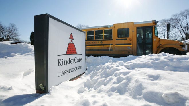 A school bus leaves KinderCare  in Palatine, Ill., on Thursday, Feb. 5, 2015.  Public health officials say they are investigating a cluster of measles cases that  includes five children under age 1 in the suburban Chicago school.