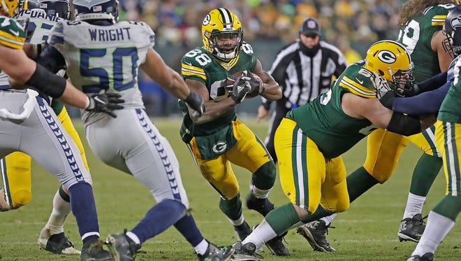 Green Bay Packers wide receiver Ty Montgomery (88) runs through a hold in the line against the Seattle Seahawks at Lambeau Field, Sunday, December 11, 2016.