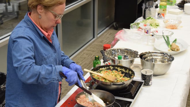 Frances Boudreaux, director of the Good Food Project, prepares Cauliflower "Fried Rice" for the Rapides Parish Library's program on preparing healthy meals. The program is held on the first Monday of every month. Boudreaux also cooked chicken to add to the "fried rice" and prepared hummus.