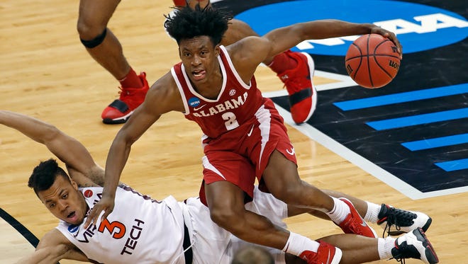 Alabama 's Collin Sexton (2) collides with Virginia Tech's Wabissa Bede (3) and draws an offensive foul during the second half of an NCAA men's college basketball tournament first-round game in Pittsburgh, Thursday, March 15, 2018. Alabama won 86-83. (AP Photo/Gene J. Puskar)