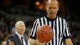 Referee John Hampton sighs as he walks away from a