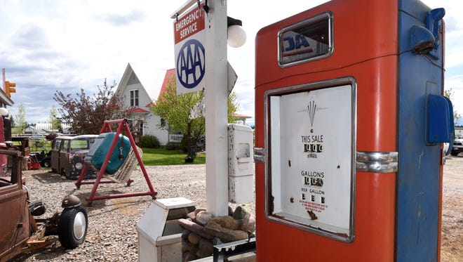 In this May 17, 2017 photo, a gas pump sits out front of a gas station at Peddler'z Village in Columbia Falls, Mont. Mike Craner opened Peddler’z Village to the public five years ago. The village has a wide range of collectibles but is heavy on old gas pumps, signs and all things related to the old glory days of the automobile industry.  (Aaric Bryan/Daily Inter Lake)/The Daily Inter Lake via AP)