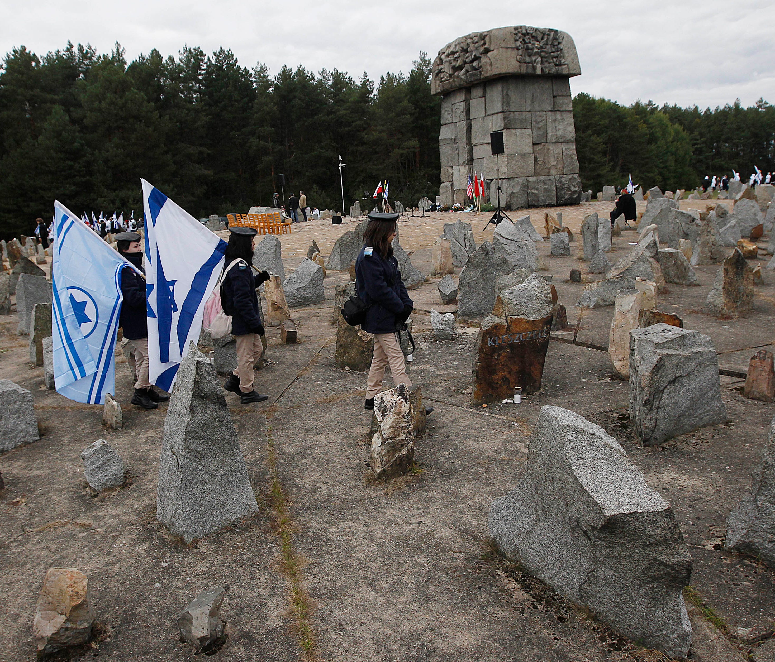 In this file photo dated Wednesday, Oct. 2, 2013, Israeli youths with their national flags march by the monument to some 900,000 European Jews killed by the Nazis between 1941 and 1944 at the Treblinka death and labor camp, at Treblinka memorial, Pol