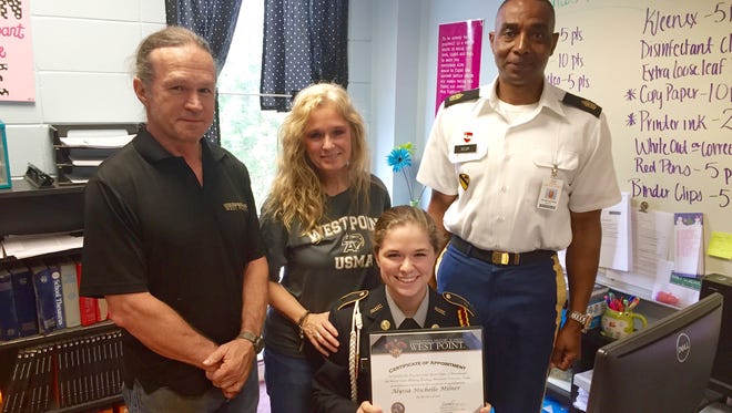 Alyssa Milner, a senior at Natchitoches Central High School, proudly holds her certificate of appointment to the United States Military Academy at West Point. With her are 1st. Sgt. Michael Selby, her JROTC leader, and parents Mark and Monique Milner.