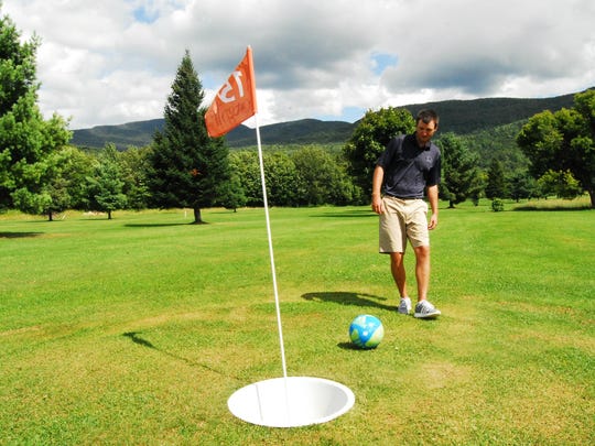 Colin O’Brien attempts a putt for par while demonstrating the play of FootGolf at West Bolton Golf Club on Wednesday. The new sport uses standard soccer balls on a specially-designed course alongside the regular golf holes.