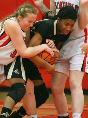Rush Henrietta's Dana Watts, center, fights for the ball with Penfield's Ali Fitzgerald and Emma Guy.