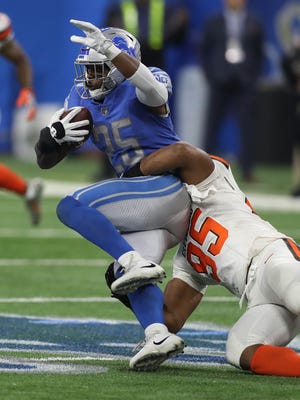Lions running back Theo Riddick is tackled by Browns defensive end Myles Garrett during the Lions' win Sunday at Ford Field.