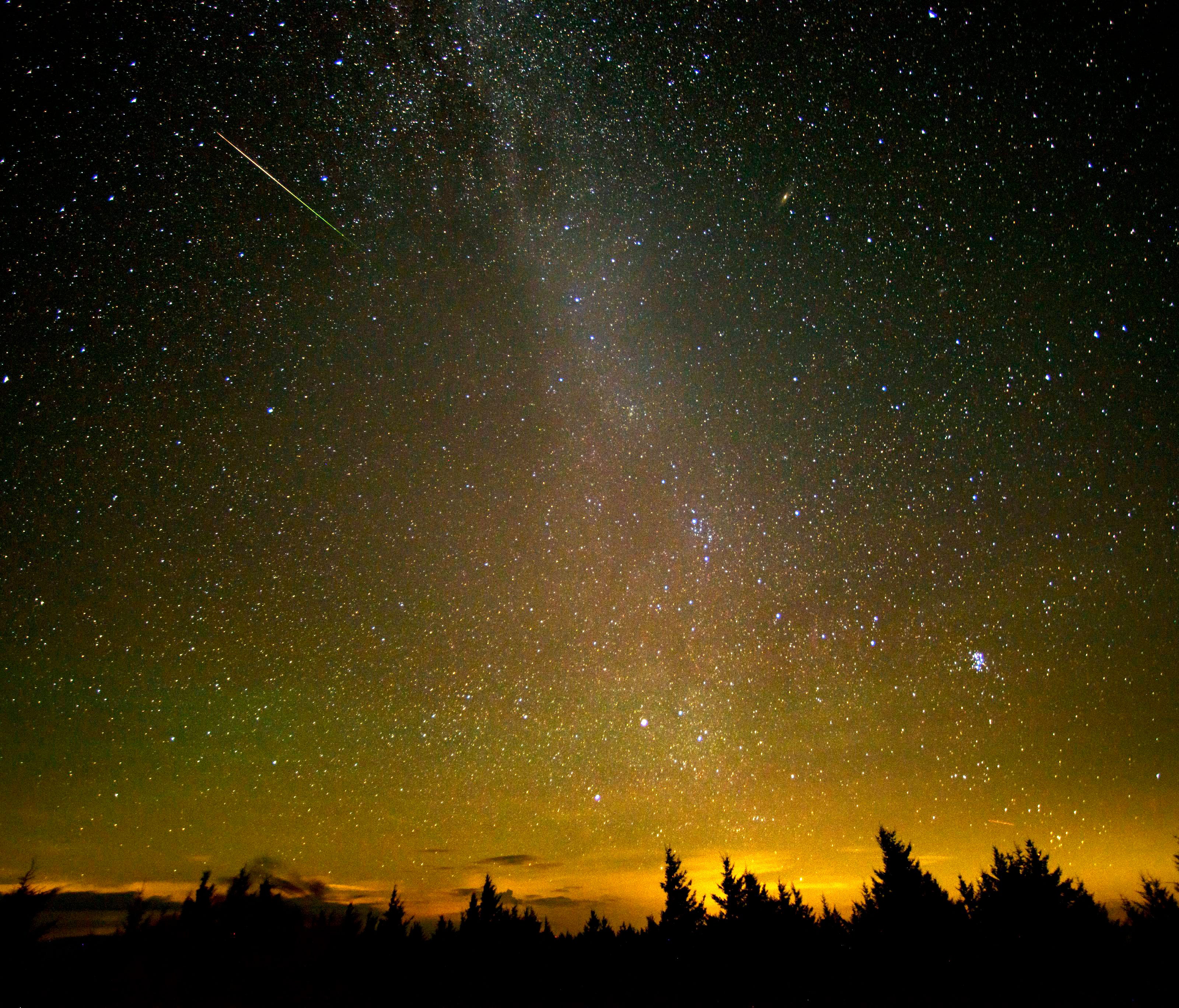 In this 30 second exposure a meteor streaks across the sky during the annual Perseid meteor shower, in Spruce Knob, West Virginia.