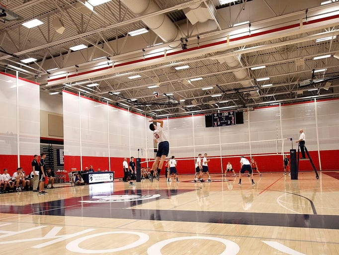 Brookfield East's Jacob Sirny leaps up to serve against