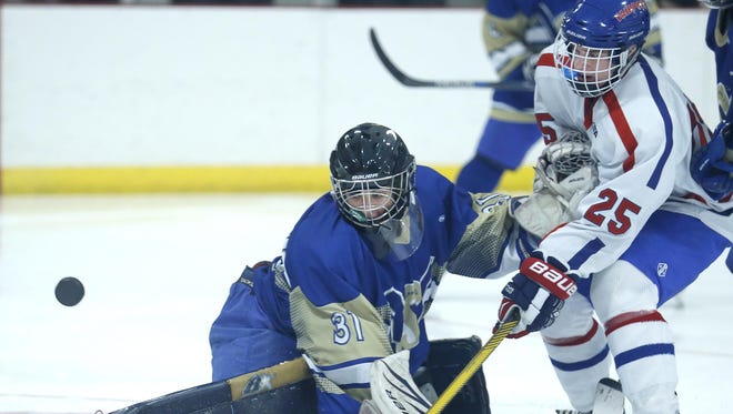 Webster Schroeder goalie Payton Hall defends against Fairport's Jonathan Newcombe in the second period at Thomas Creek Ice Arena.