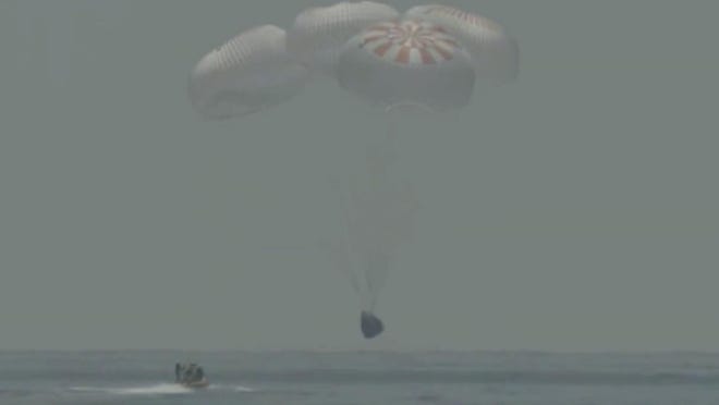 In this frame grab from NASA TV, the SpaceX capsule splashes down Sunday in the Gulf of Mexico. Astronauts Doug Hurley and Bob Behnken spent a little over two months on the International Space Station.