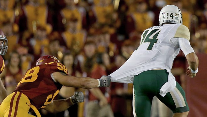 Iowa State's Cory Morrissey, left, was unable to make the tackle as Baylor quarterback Bryce Petty broke away during a game at Jack Trice Stadium in Ames on Saturday night.