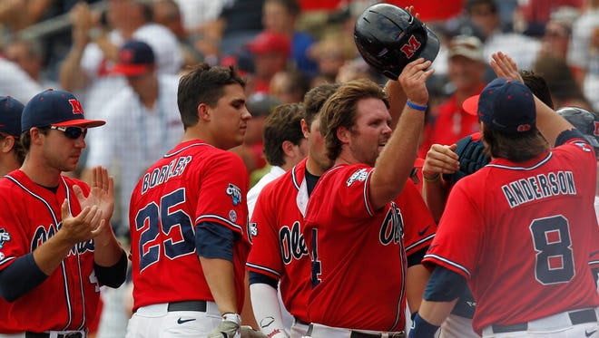 Jun 17, 2014; Omaha, NE, USA; Mississippi Rebels runner Sikes Orvis (24) celebrates after scoring a run against the Texas Tech Red Raiders during game seven of the 2014 College World Series at TD Ameritrade Park Omaha. Mandatory Credit: Bruce Thorson-USA TODAY Sports