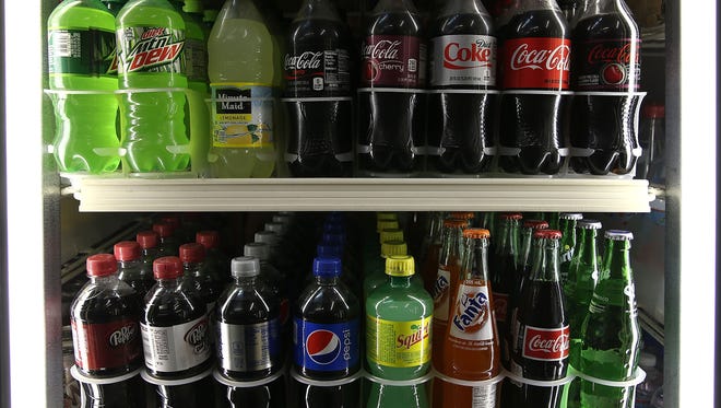 SAN FRANCISCO, CA - JUNE 10:  Bottles of soda are displayed in a cooler at a convenience store on June 10, 2015 in San Francisco, California. The San Francisco board of supervisors has approved an ordinance that would require warning labels to be placed on advertisements for soda and sugary drinks to alert consumers of the risk of obesity, diabetes and tooth decay. The ordinance would also ban advertising of sugary drinks on city-owned property. If San Francisco mayor Ed Lee approves the  measure, the law would be the first of its kind in the nation.  (Photo by Justin Sullivan/Getty Images)