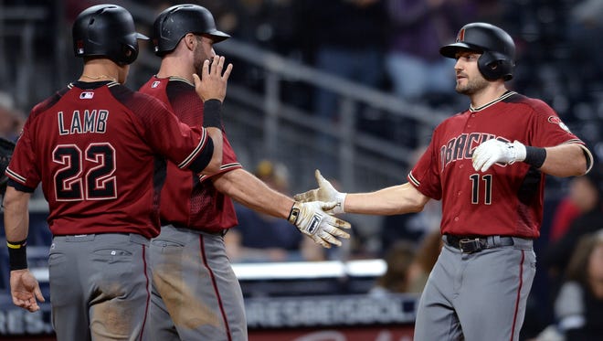 Arizona Diamondbacks' A.J. Pollock is congratulated at home plate by Jake Lamb and Paul Goldschmidt after hitting a three-run home run during the ninth inning of a baseball game against the San Diego Padres on Wednesday, Sept. 20, 2017, in San Diego. (AP Photo/Orlando Ramirez)