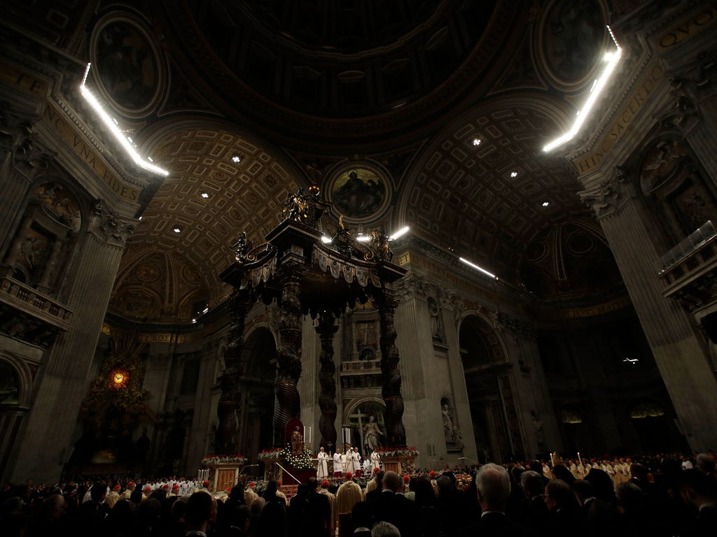 Pope Francis, background center, celebrates the Christmas Eve Mass in St. Peter's Basilica at the Vatican.