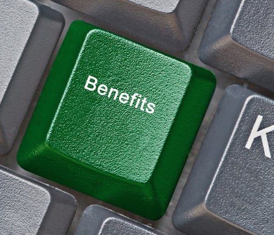 Grey keyboard with green key marked Benefits.