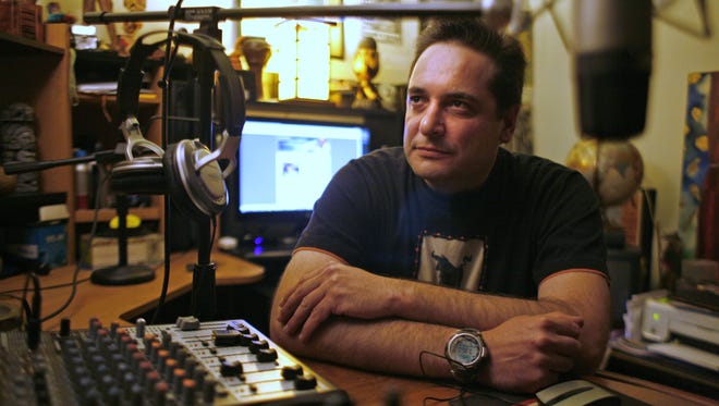 Matias Trejo De Dios is photographed in his radio studio in his West Salem home on Wednesday, June 16, 2010. Matias wears many hats; working at the Oregon Lottery, teaching Dad Boot Camp at Salem and Silverton Hospital,  and most importantly being a father, just to name a few.