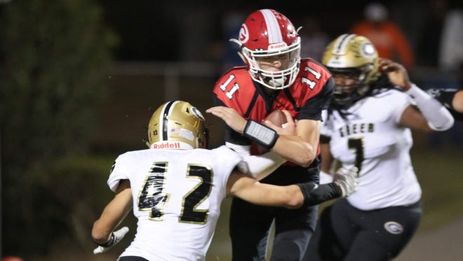 Greenville's Davis Beville (11) on the keeper in the first quarter taken down by Greer's Brodie Wright (42).