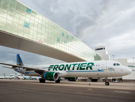 A Frontier Airbus A321 passes under the landmark pedestrian