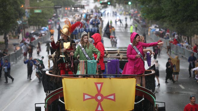 Floats roll down Monroe Street as the skies pour rain on Tallahassee's 50th anniversary Parade Saturday.