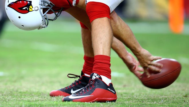 Aug 15, 2015: Detailed view as Arizona Cardinals long snapper Mike Leach snaps the ball against the Kansas City Chiefs in a preseason NFL football game at University of Phoenix Stadium.