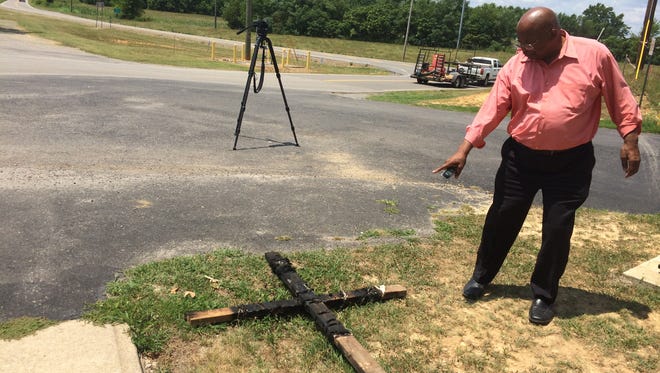 Pastor Vernon Woods arrived at Clarksville's New Hope Missionary Baptist Church to find a burned cross Tuesday morning.