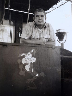 Jerry McGill is pictures on an 82 U.S. Coast Guard Patrol boat behind the flag box mascot from Warner Bros. McGill was awarded the Bronze Star while serving in Vietnam.
