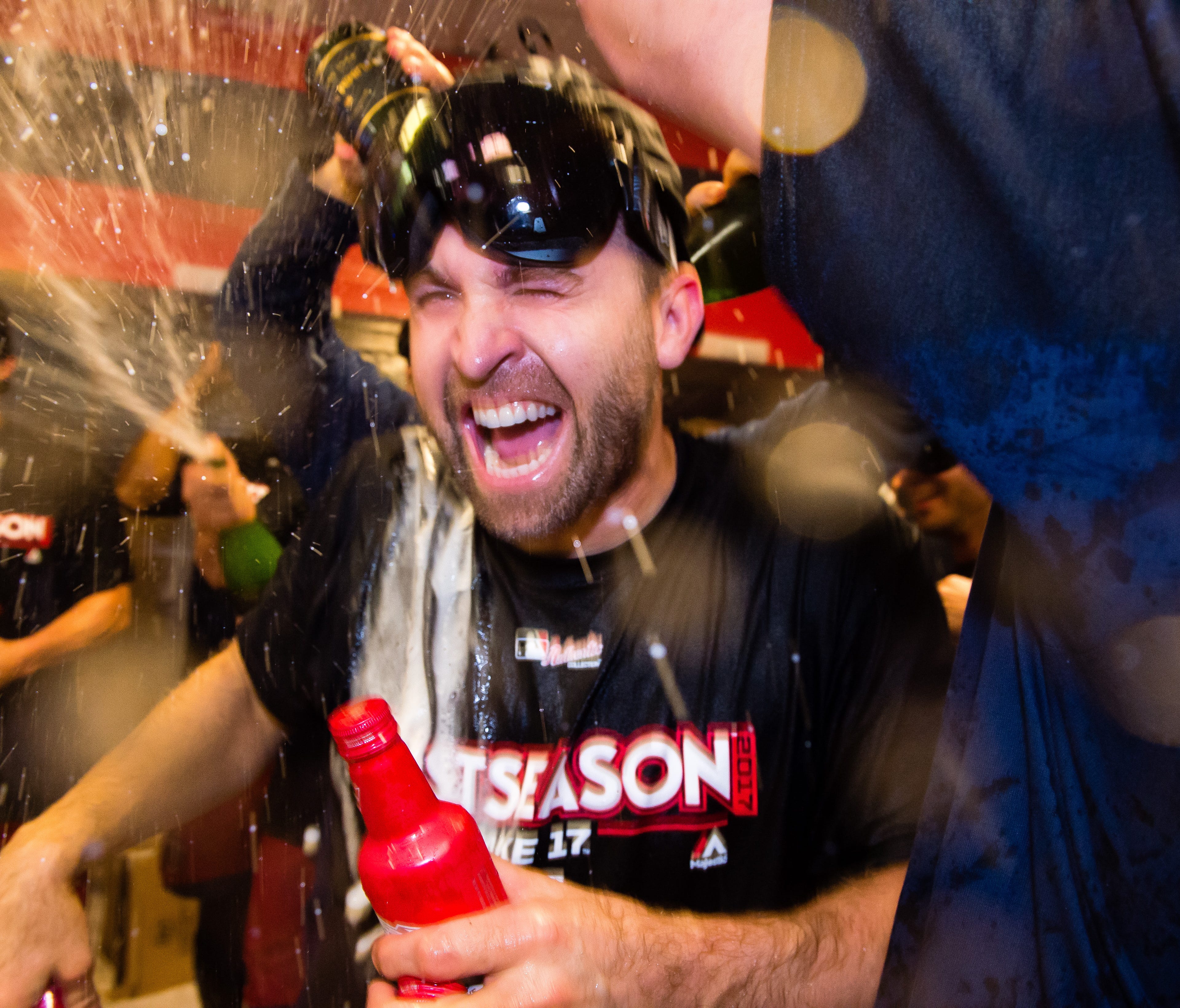 Brian Dozier celebrates with his teammates after the Twins clinched the second AL wild card spot.