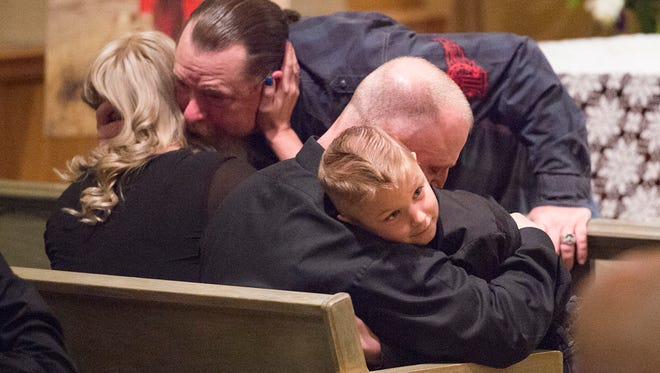 Family members comfort each other before a memorial service for Cody Risk at Bohlender Funeral Chapel on Thursday, February 8, 2018. Risk, 26 from Wellington, is among five people killed in an oil rig explosion near Quinton, Oklahoma. 
