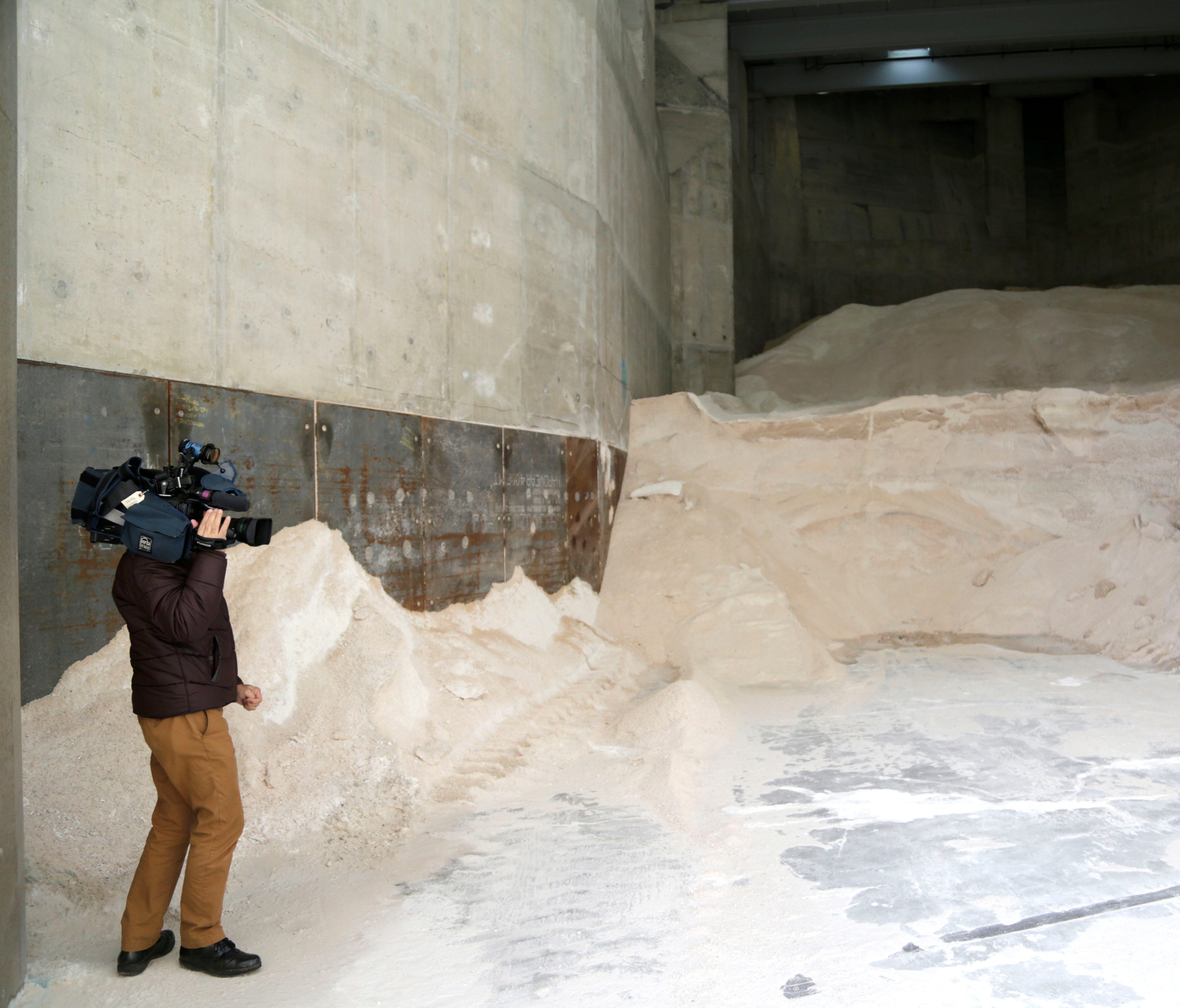A reporter films salt that is ready for use on the streets in New York as the area prepares for Stella March 12, 2017.