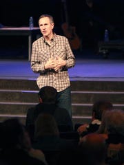 Pastor John Lindell leads a prayer service at James River Assembly in Ozark, MIssouri, in this file photo from 2013.