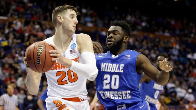 Syracuse's Tyler Lydon, left, looks to pass around Middle Tennessee's Giddy Potts during the second half of a second-round men's college basketball game in the NCAA Tournament, Sunday, March 20, 2016, in St. Louis. Syracuse won 75-50. (AP Photo/Jeff Roberson)