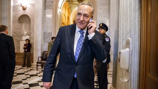 Sen. Chuck Schumer, D-N.Y., uses his cell phone at the U.S. Capitol in Washington, on Jan. 29, 2015.