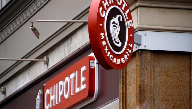 This Monday, Feb. 8, 2016, photo, shows the marquis signs for the Chipotle restaurant in Pittsburgh's Market Square. Chipotle announced Thursday, July 28, 2016, that the company's first Tasty Made burger restaurant will open in the fall in Lancaster, Ohio. No other details were immediately available. (AP Photo/Keith Srakocic)
