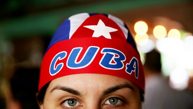 Michelle Chavez of Miami poses for a portrait wearing a Cuba head wrap in celebration of the death of Fidel Castro along "Calle Ocho," or 8th Street, in Little Havana, Miami on Friday, Nov. 26, 2016. Castro's death was announced by Cuban state television on Friday.