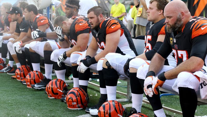 Cincinnati Bengals tackle Andrew Whitworth (77), right foreground, guard Clint Boling (65) Cincinnati Bengals center Russell Bodine (61) Cincinnati Bengals guard Kevin Zeitler (68) and their teammates in the finals minutes of their loss to the Denver Broncos at Paul Brown Stadium Sunday September 25, 2016. The Bengals loss 29-17.